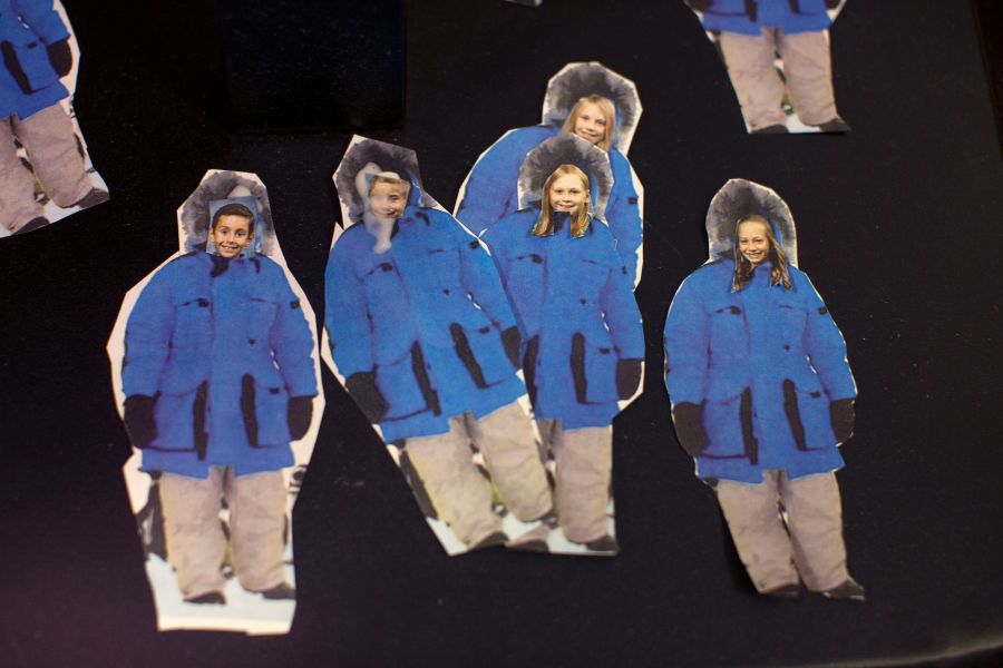 Lisa Werner creates cutouts of her students wearing blue parkas
.
