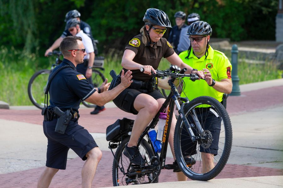 UW-Whitewater Police Detective Cal Servi, left, and Officer Nic Thompson, right, guide Walworth County Sheriff's Deputy Jocelyn Lawson in a step-climbing exercise at Cravath Lakefront Park in Whitewater.