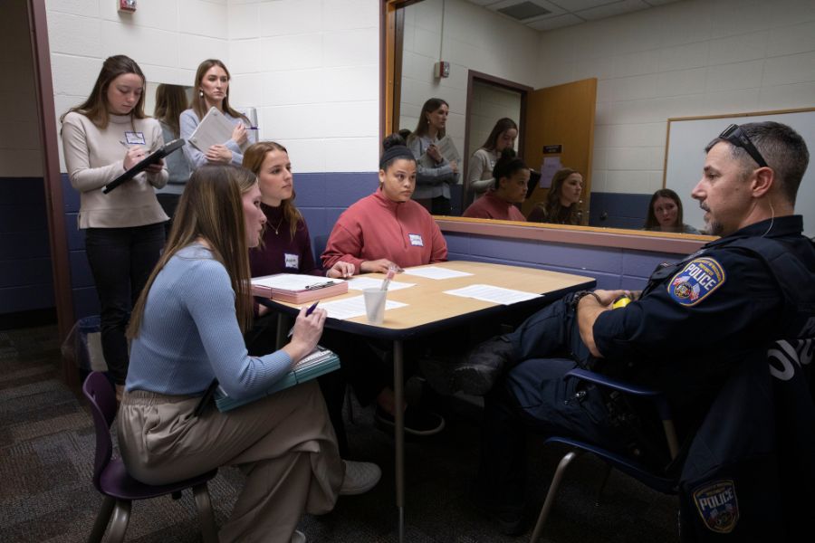 Professor is looking at student's work.