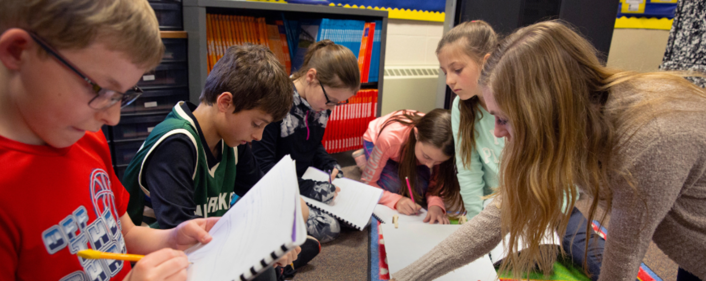 Students are doing activities on notebooks.