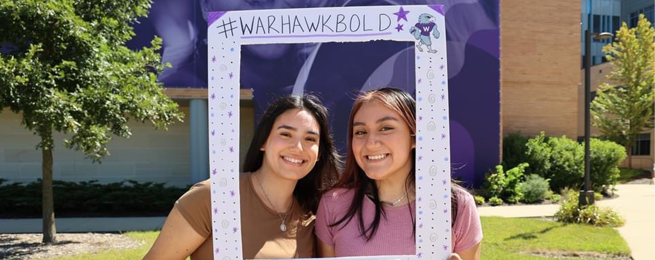 Maribel and Alma pose for a photo and smile.