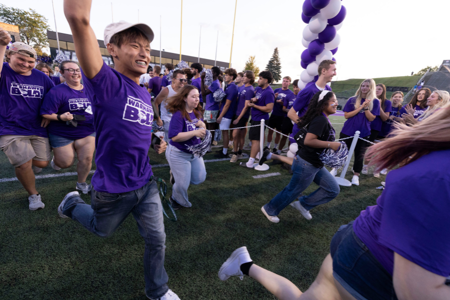 Students run through tunnel during the RU Purple tradition.