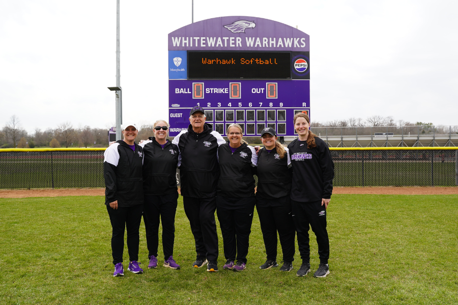 Head coach Brenda Volk, fourth from left, is joined by her coaching and support staff in 2025. Assistant coaches Beth Bonuso, second from left, and Steve Evans, third from left, have each been on Volk’s staff for 25 or more years. (UW-Whitewater athletics photo)