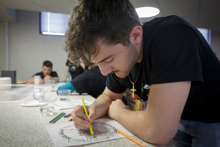 Joeseph uses colored pencils for an art activity. 