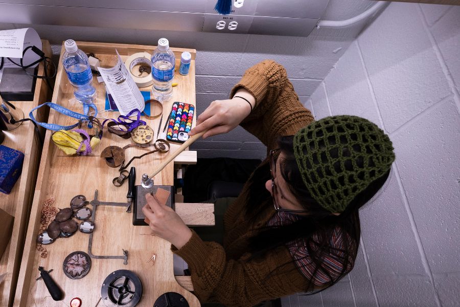Liina Heikkinen, an art student from Madison, is shown at work in the metals studio at the Greenhill Center of the Arts with some of the art she creates on Feb. 3, 2026.