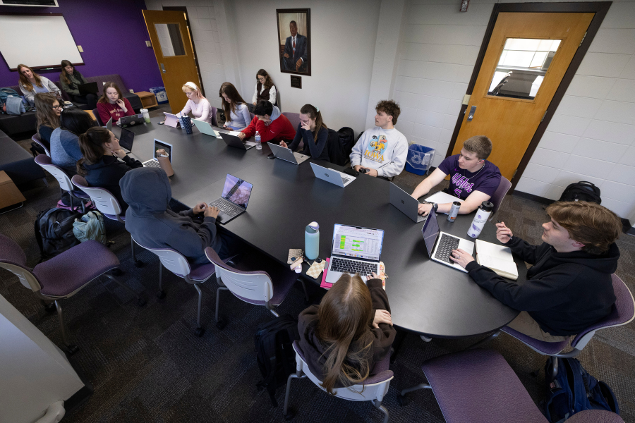 Students attend a meeting for Royal Purple. 