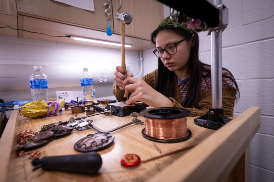 Student Liina has metal work on table.