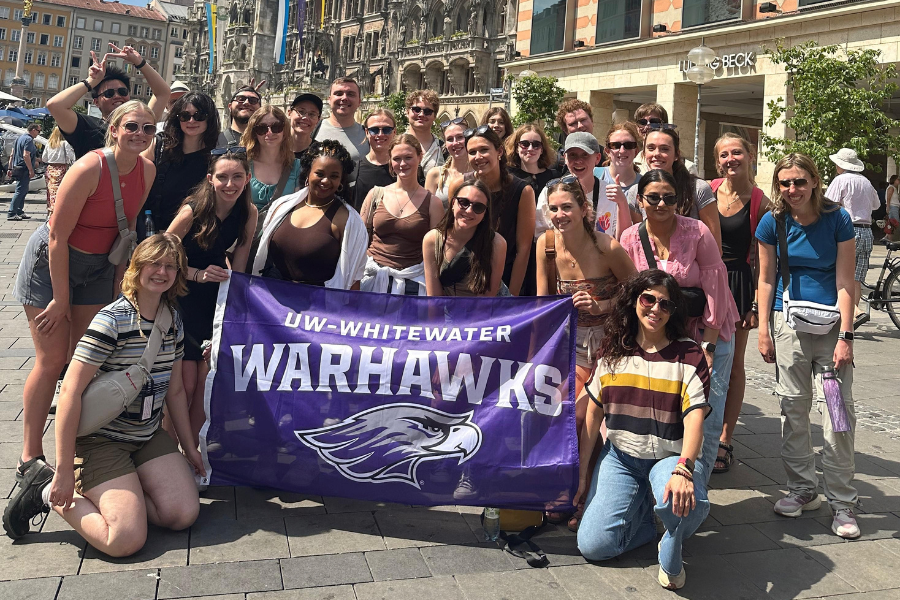 Students pose with Warhawk Flag in Germany. 