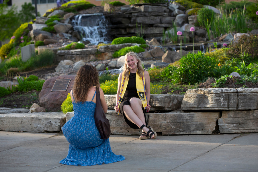 Student graduates wearing her veteran stole.