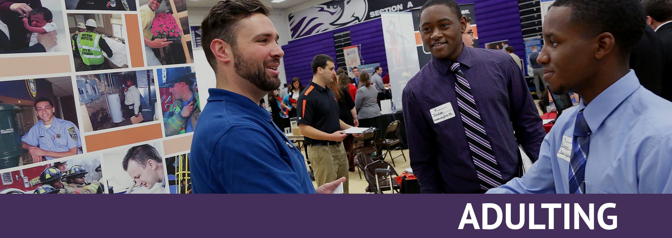 Adulting: Two students in ties shake hands with a recruiter at a job fair