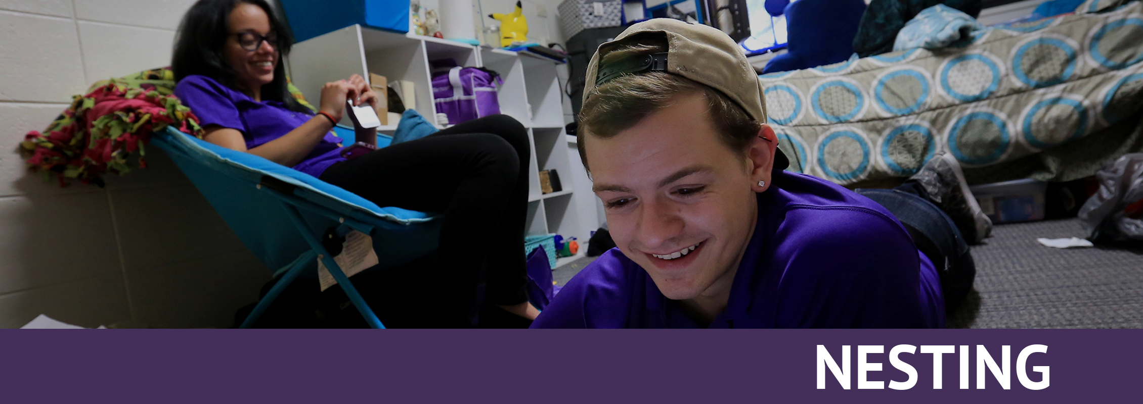 Nesting: Two students relaxing in a residence hall room