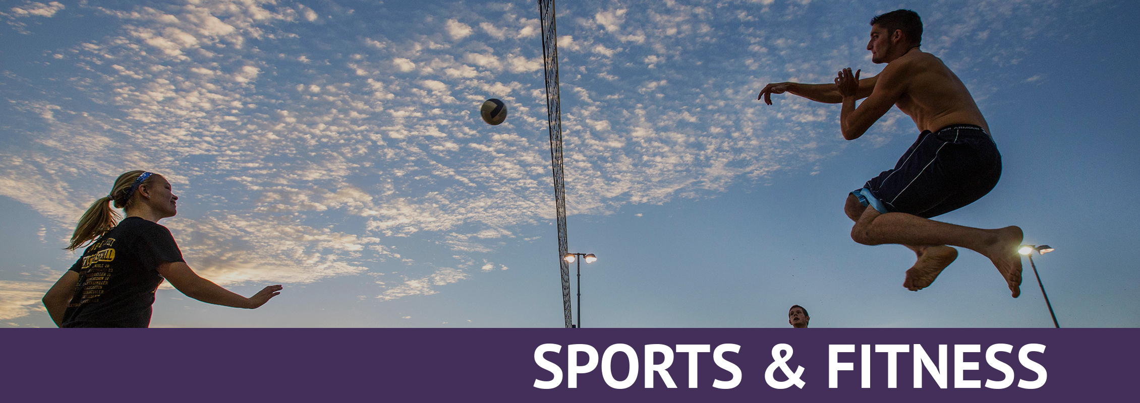 Sports and Fitness: Two students playing volleyball outdoors