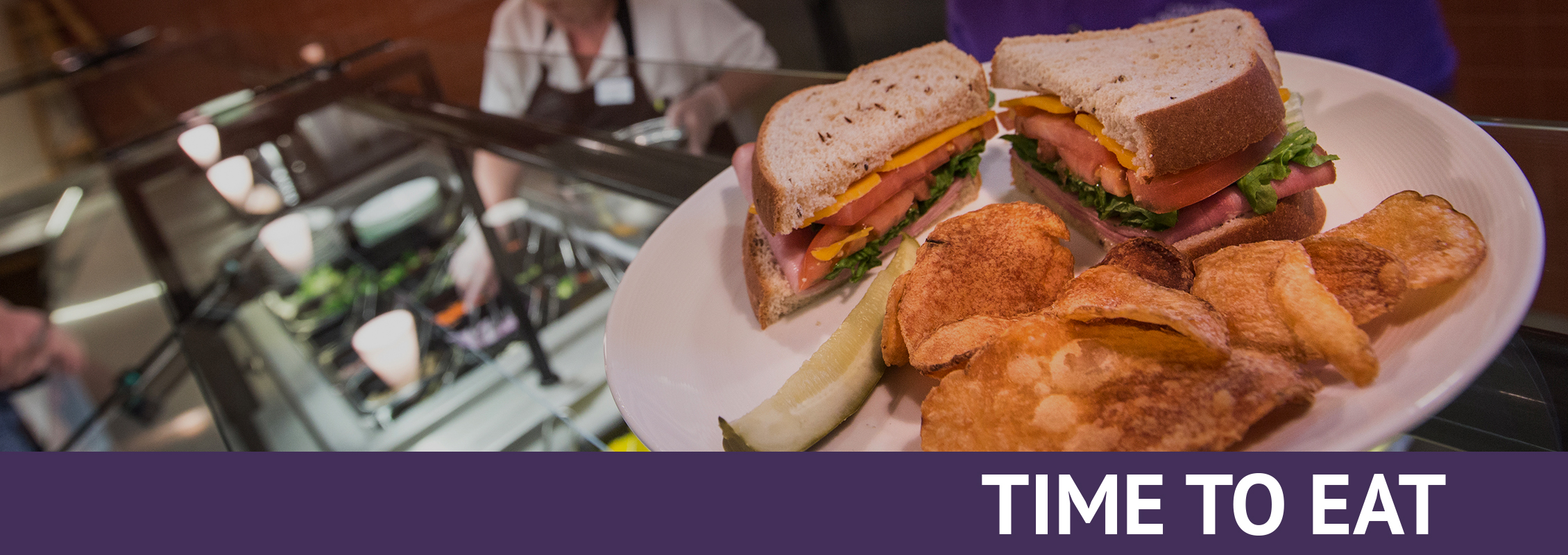 Time to Eat: A salad bar and a plate with a sandwich, chips and a pickle 