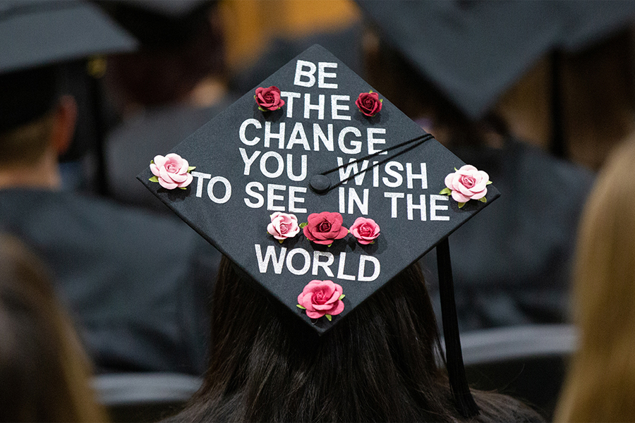 Mortar board says Be the Change You Wish to See in the World.
