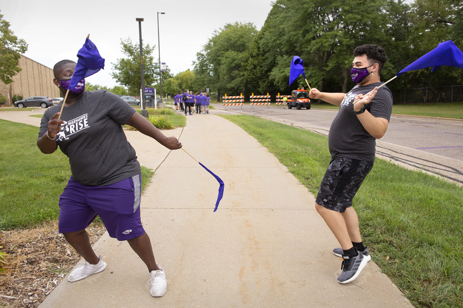 Two students dance on Warhawk Drive.