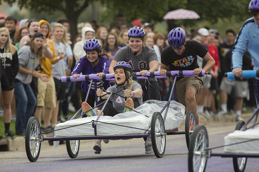 Students run in the bed races.