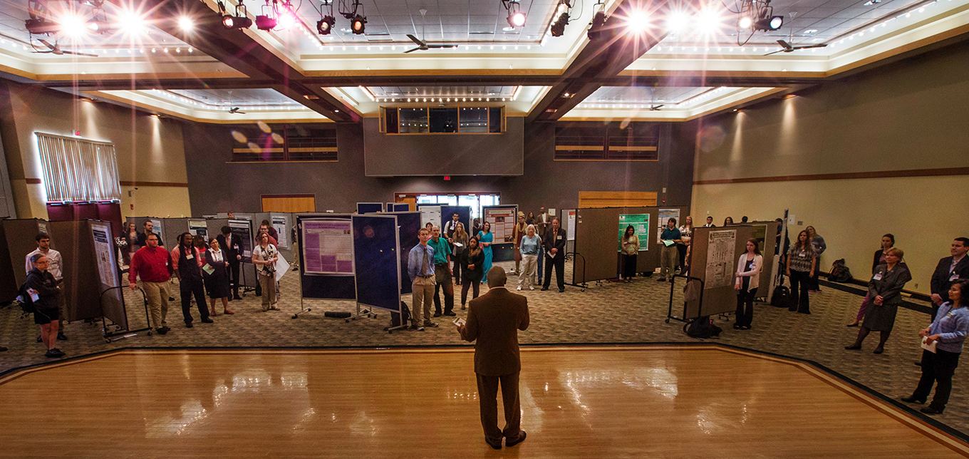 Students stand with their posters at Undergraduate Research Day.