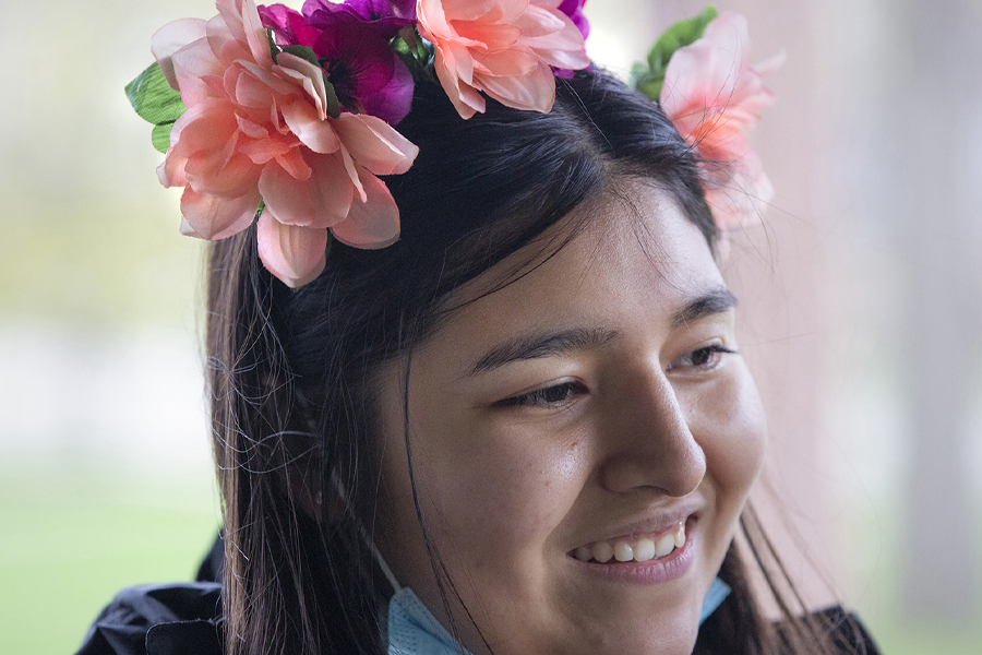 A person wearing flowers in their hair.