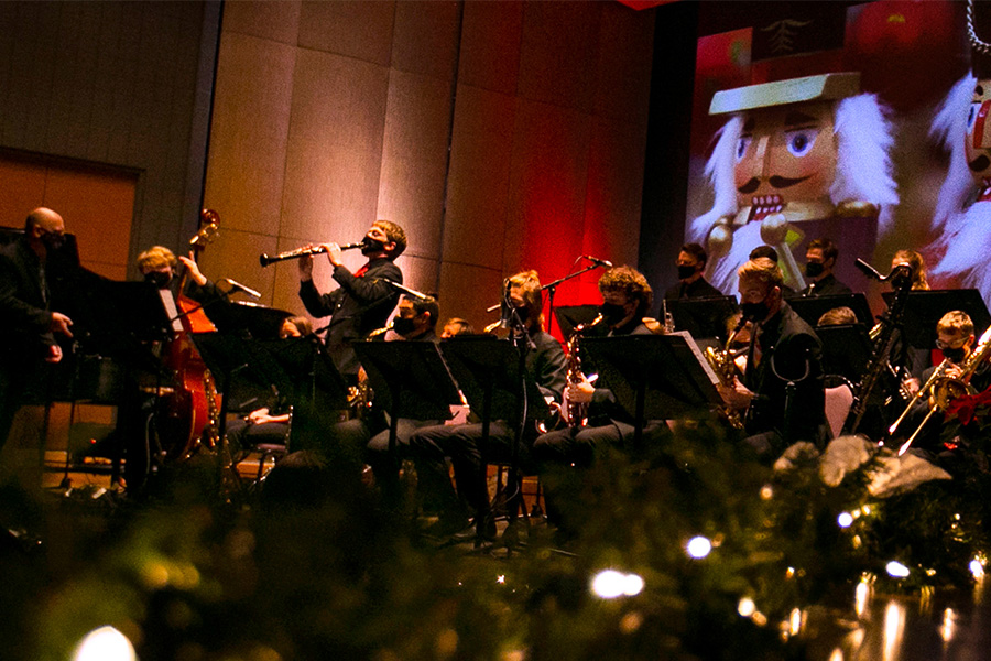 Musicians play at the Gala with a nutcracker image in the background.