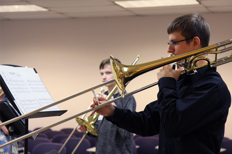 Picture of a person playing a trombone.