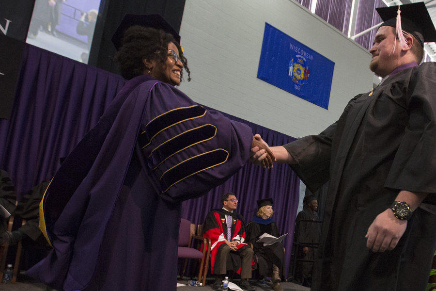 Dean Hayes shakes hands during graduation.