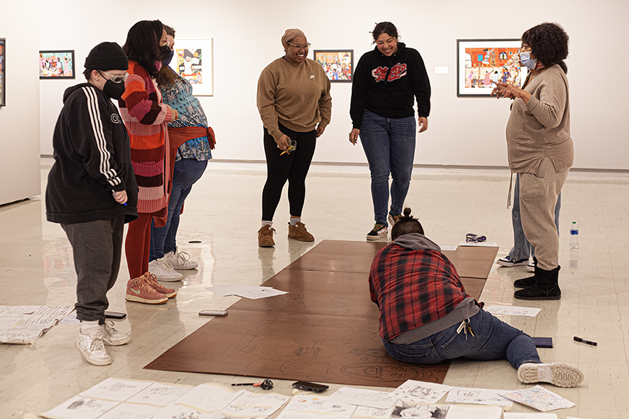 Students stand in the Crossman Gallery.