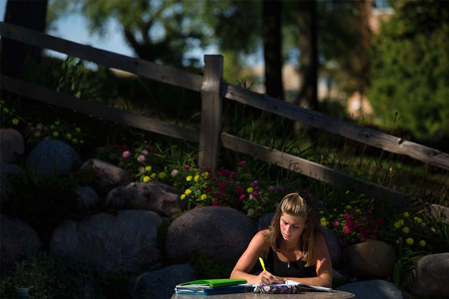 Student outside studying.