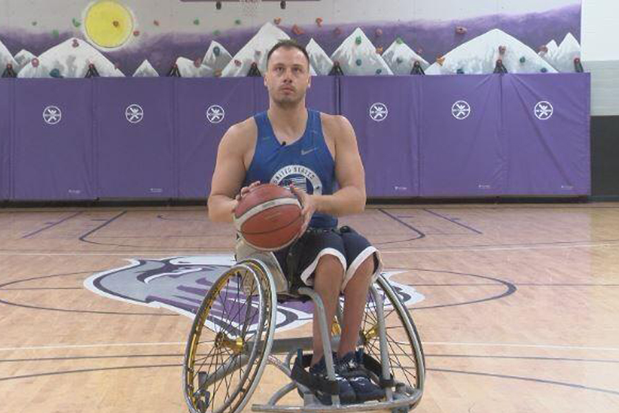 Jake Williams in a wheelchair playing basketball.