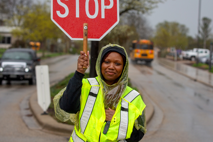 Student holding stop sign.