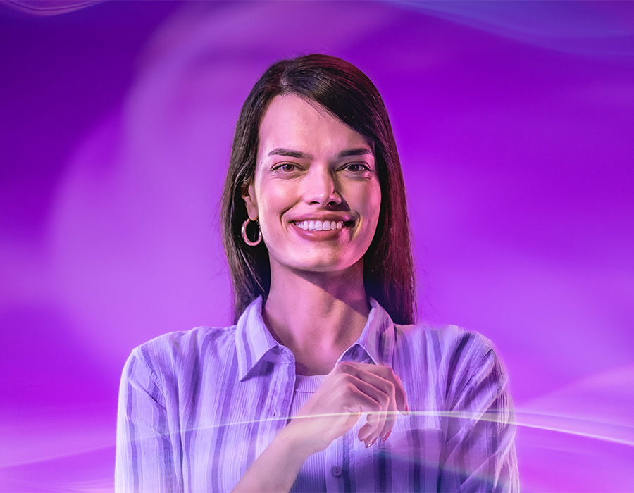 Student poses at CoBE photo shoot with purple backdrop