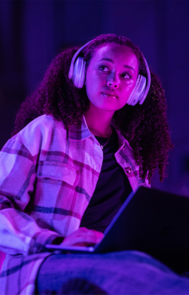 Young woman reads tablet taking online college class