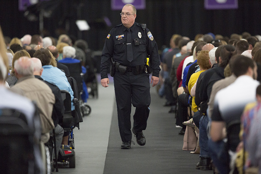 A UW-Whitewater police officer walks down the aisle of a crowded event.