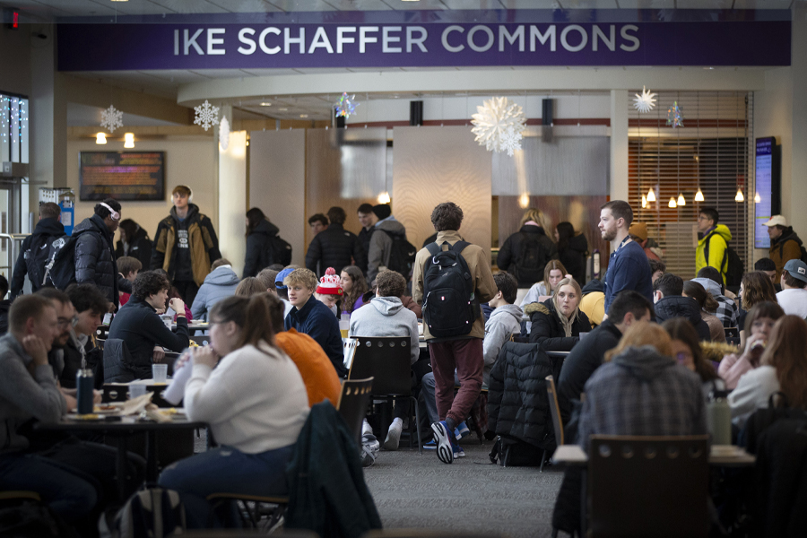 Students fill the tables in the University Center with lettering overhead that says Ike Schaffer Commons.