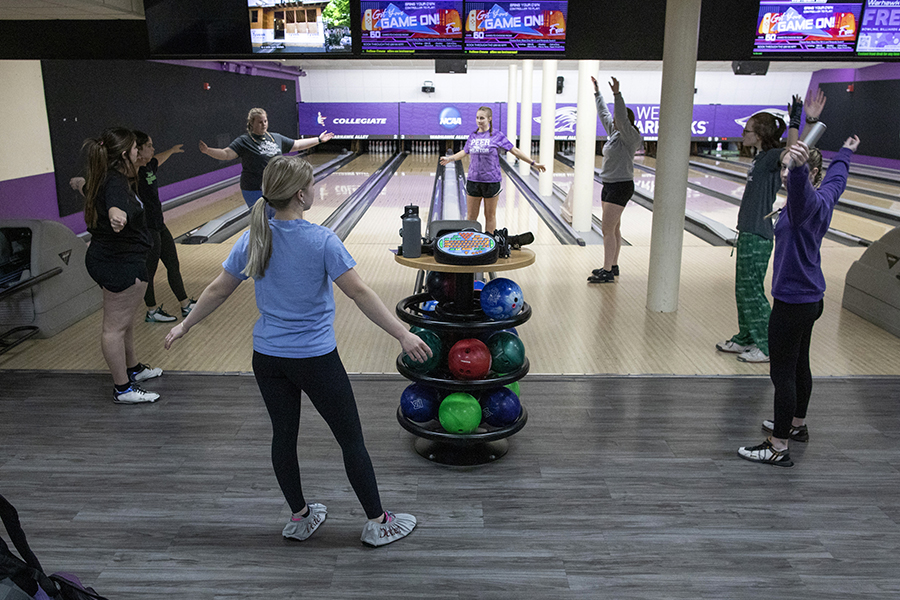 A group of students gather in front of the bowling lanes in Warhawk Alley.