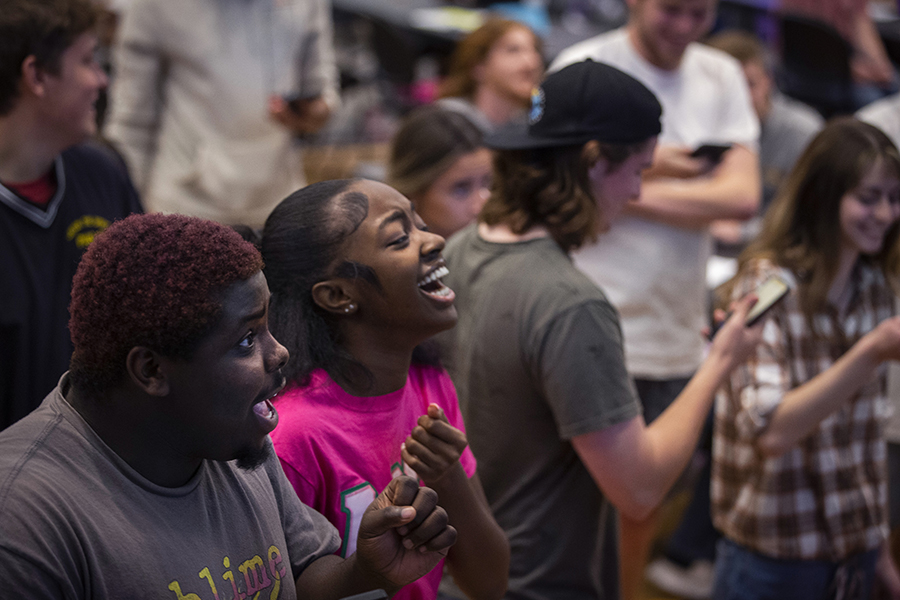 Two students laugh together at a campus event.