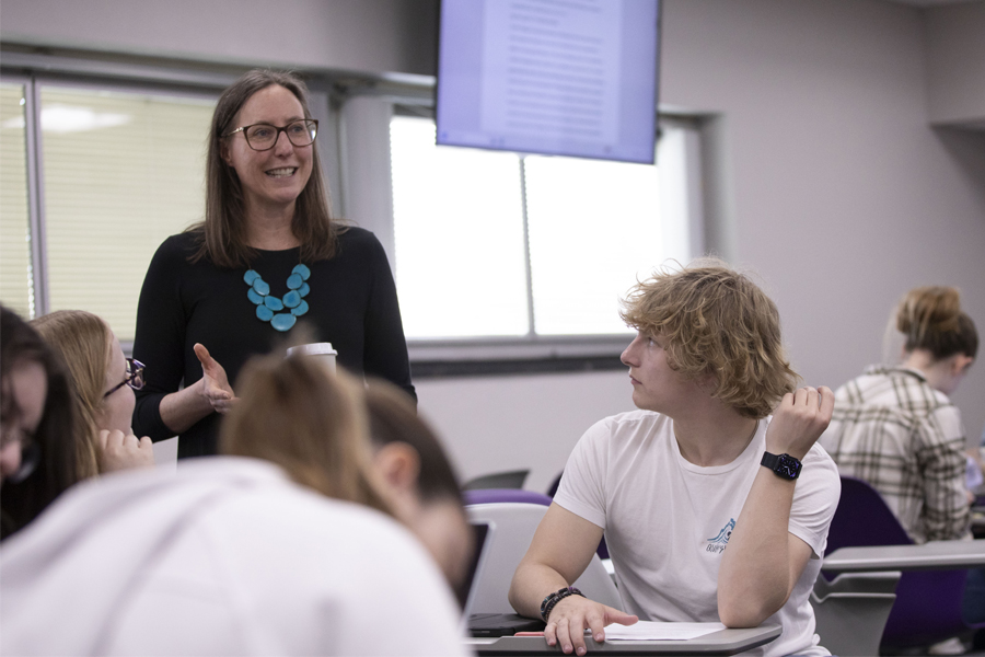 Ellie Schemenauer talking to students in classroom.