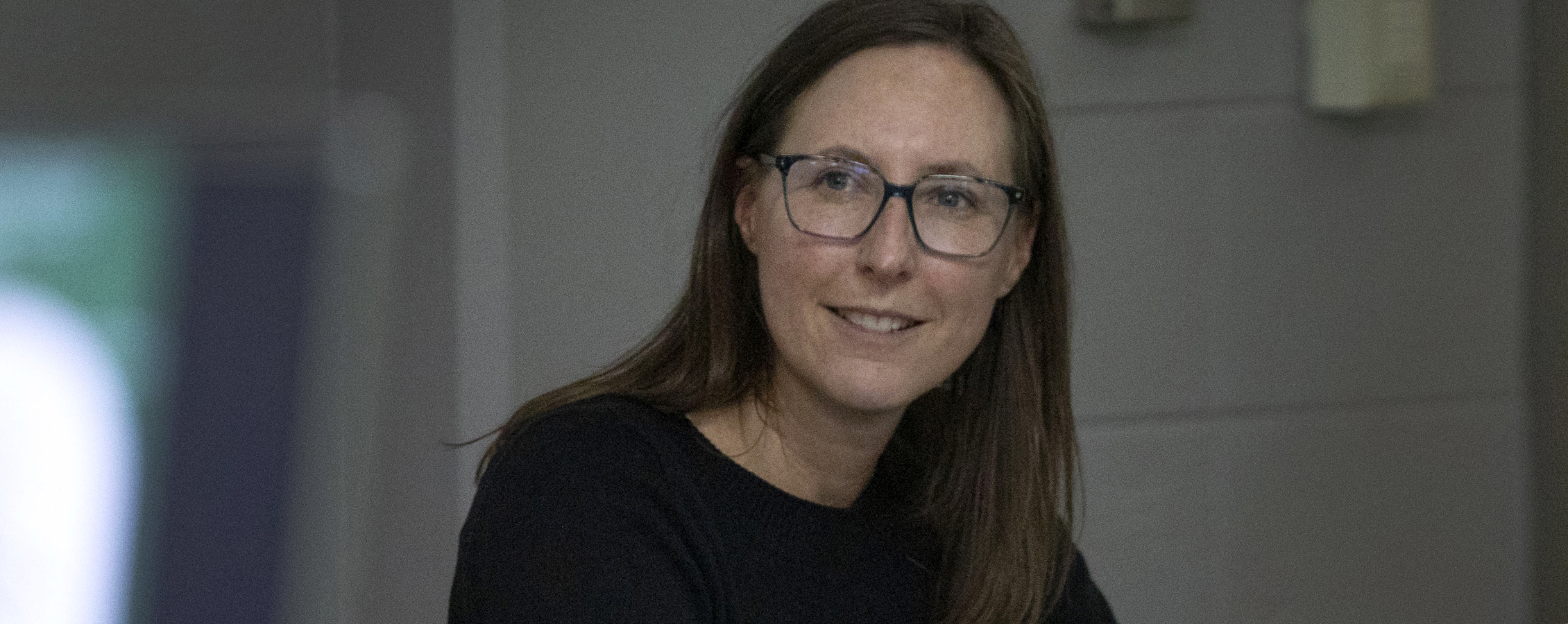 Ellie Schemenauer listens as students present their projects.