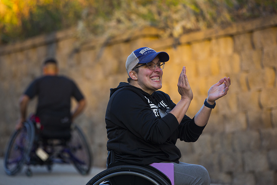Christina Schwab cheers on wheelchair basketball players.