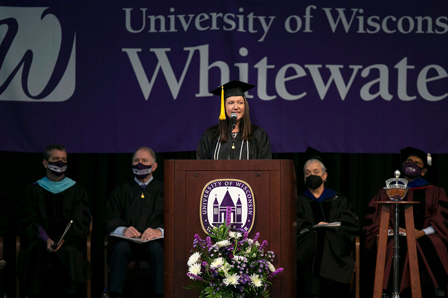 Melissa Dix speaks at the podium during commencement.