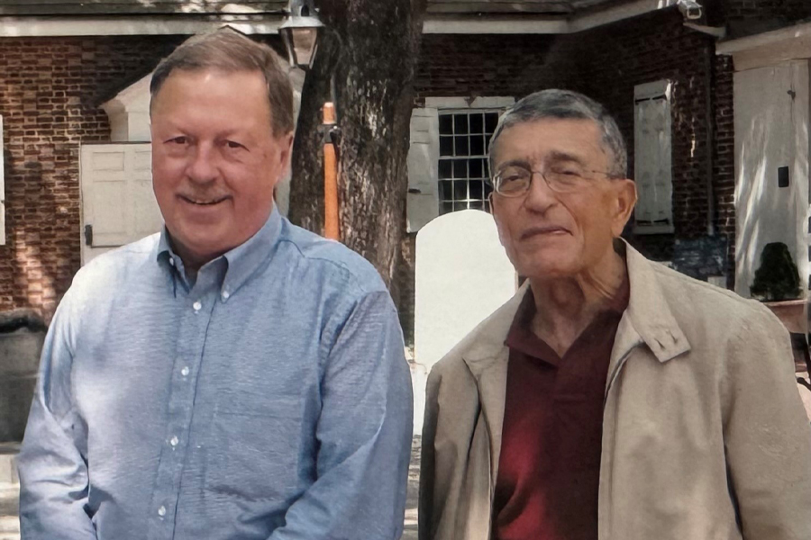 Two people smile at the camera.